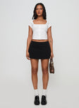 front view of model wearing Princess Polly Sora Skort Black High Waisted Shorts 