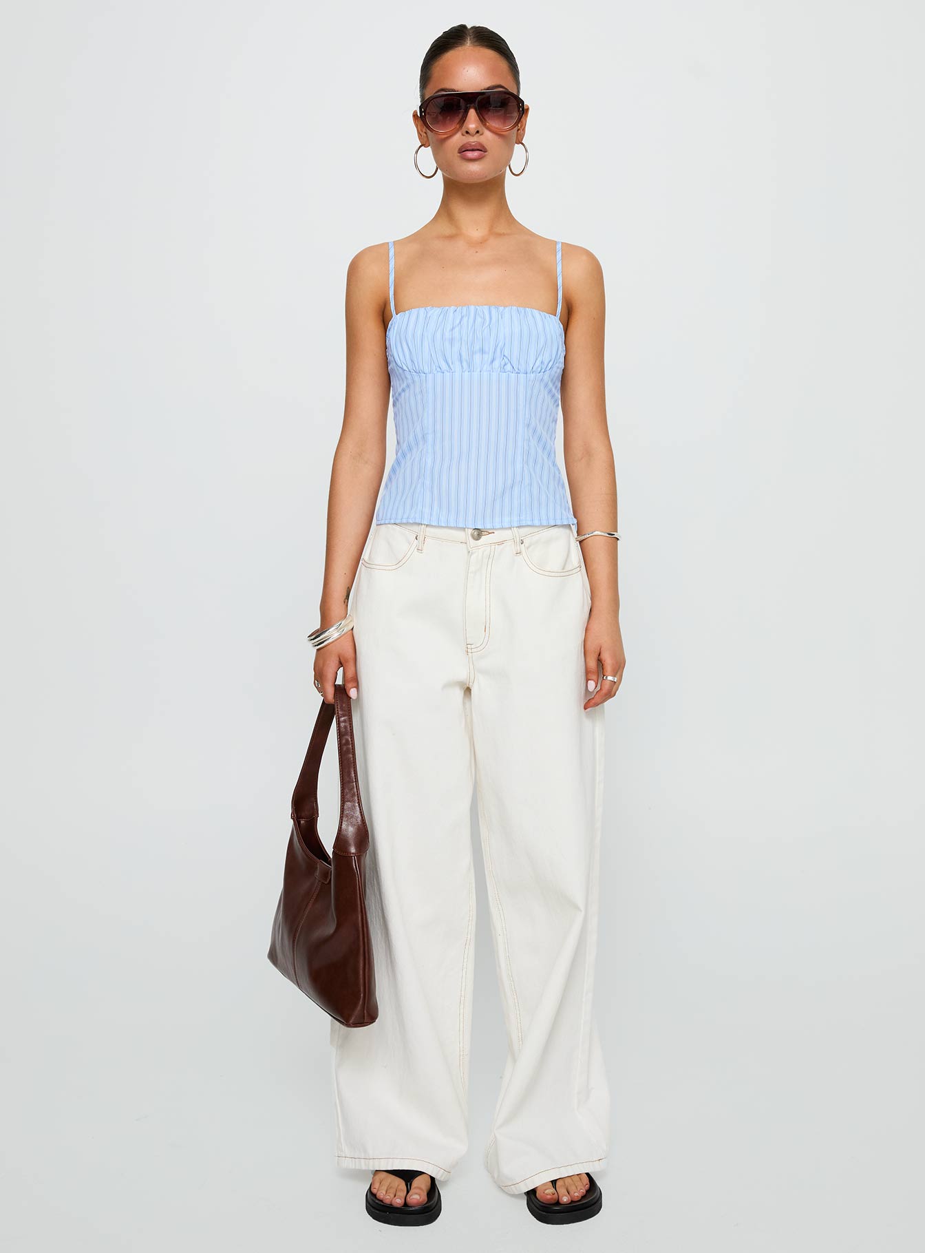 side view of model wearing Princess Polly Isolabella Top Blue Stripe Sleeveless Square Neck 