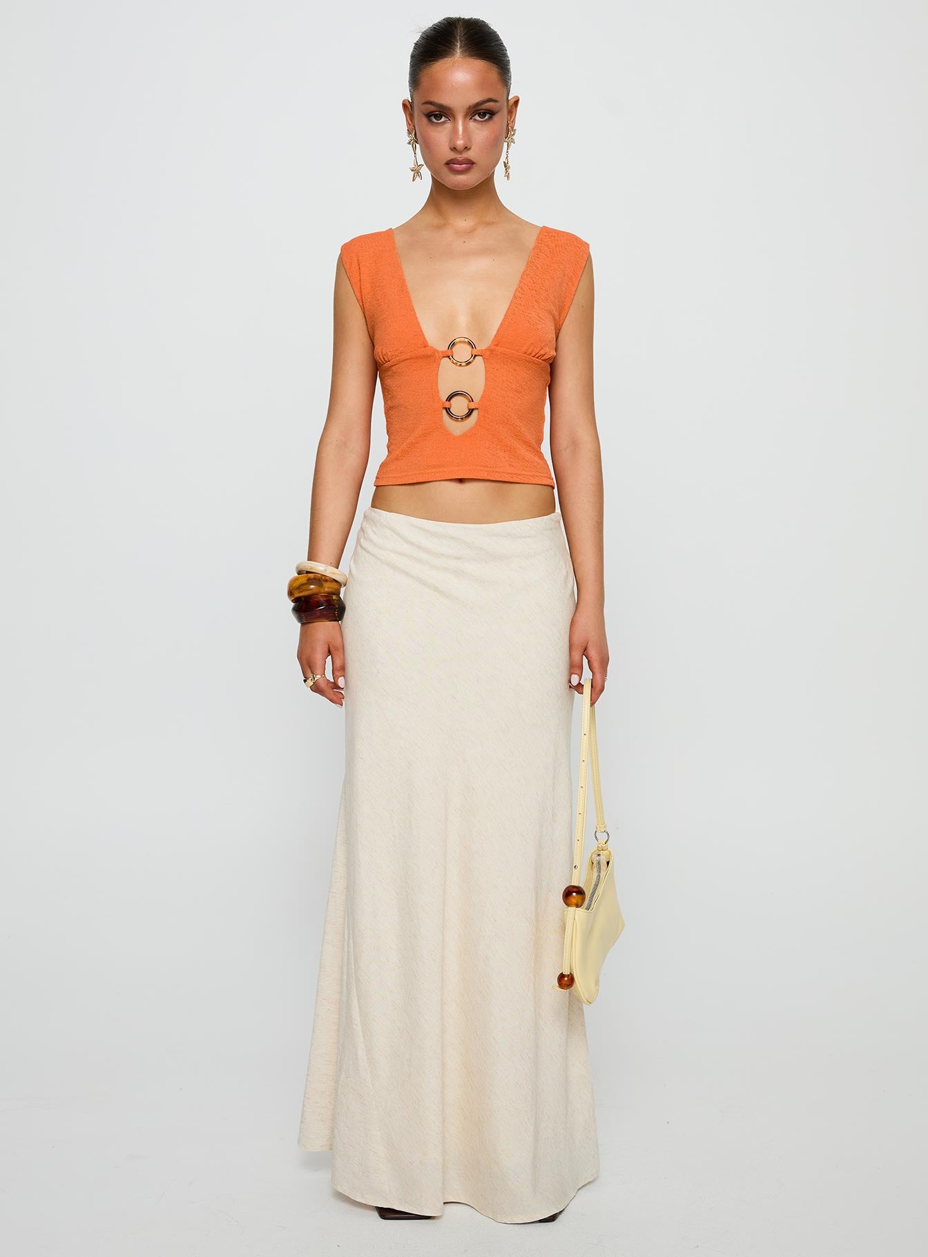 side view of model wearing Princess Polly Steward Top Orange Sleeveless Plunger 