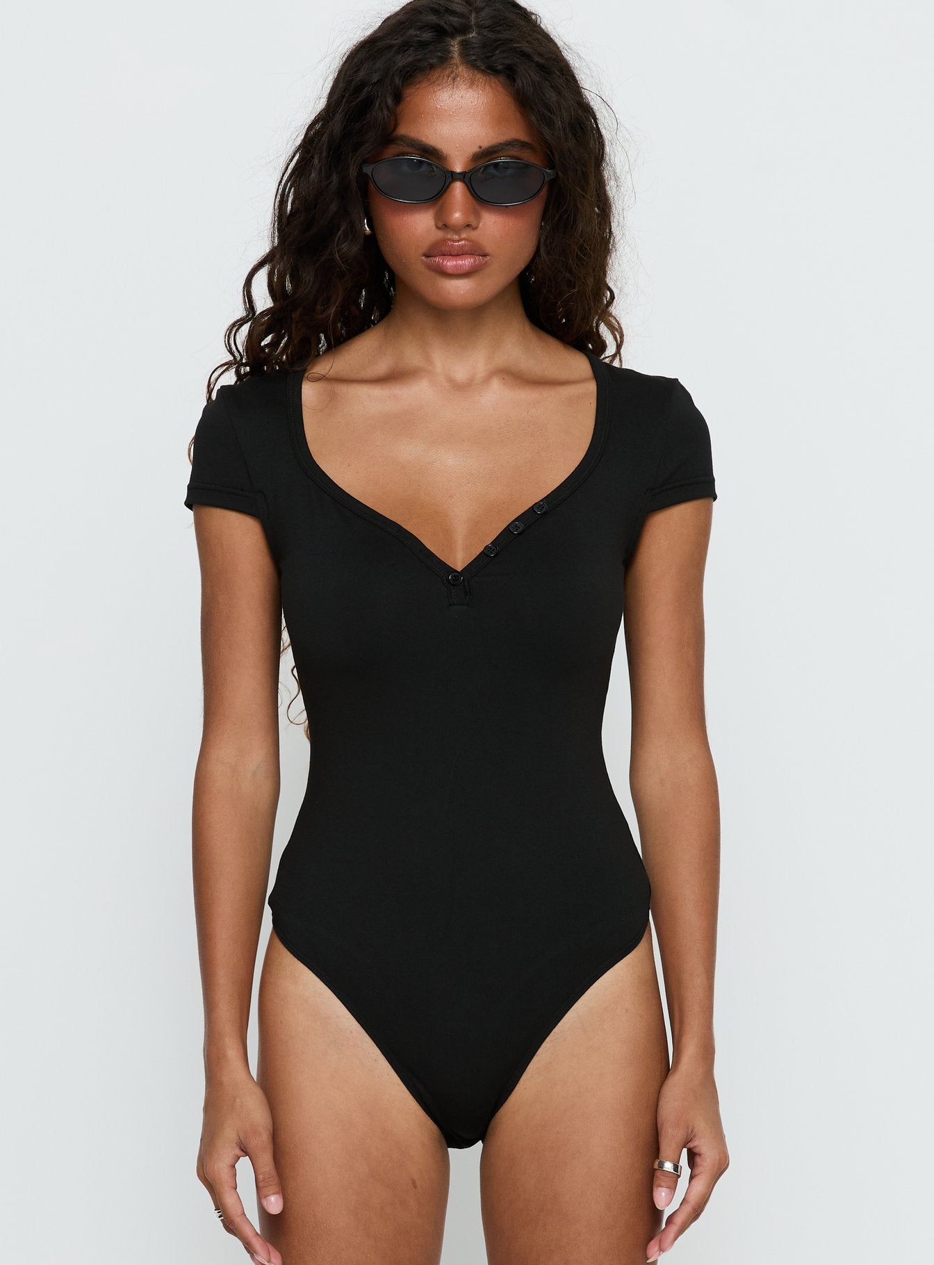 front view of model wearing Princess Polly Laretta Button Up Bodysuit Black Short Sleeve 