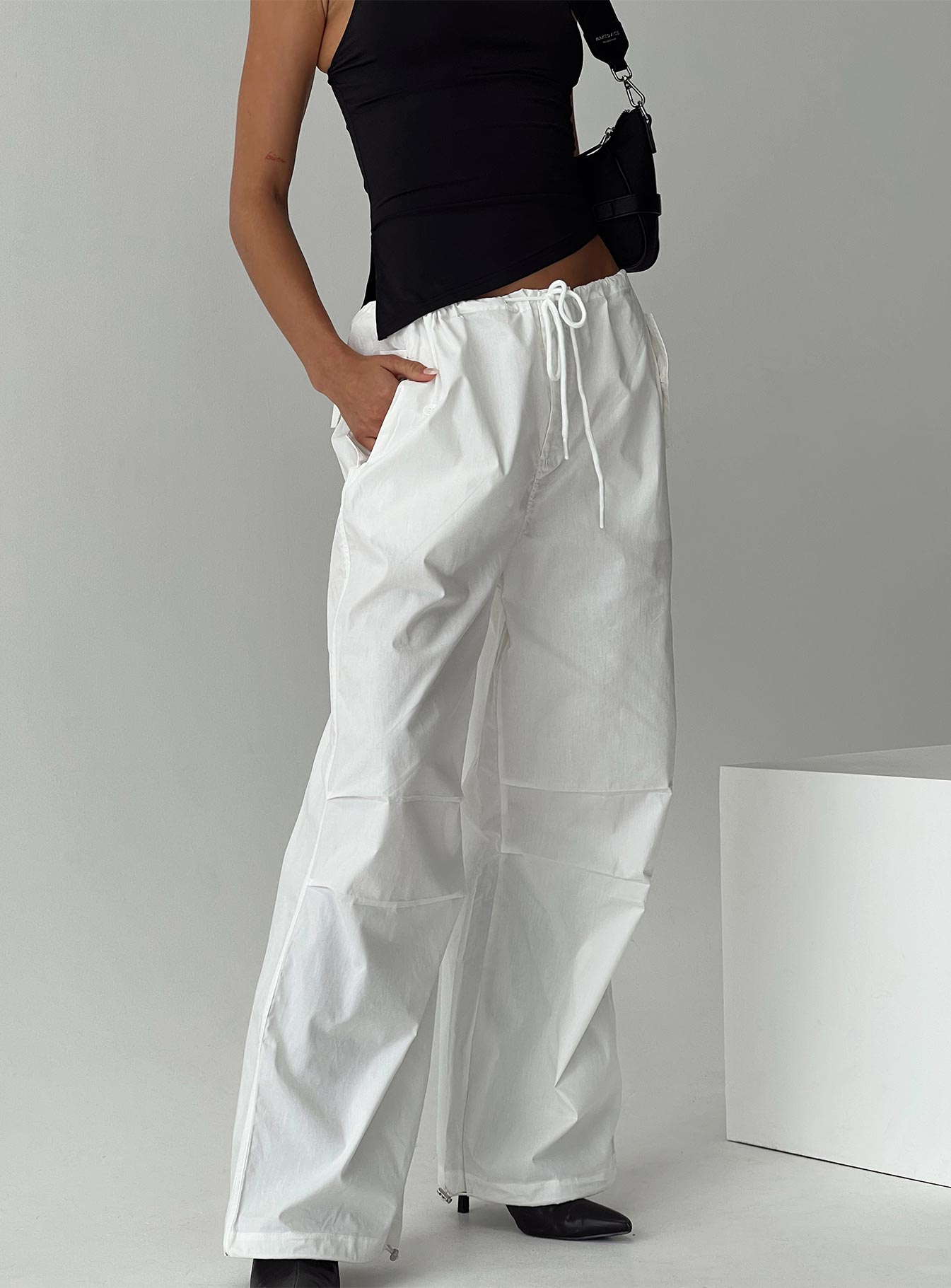 side view of model wearing Princess Polly Blessings Tie Front Cotton Pant White Low Rise Pants 