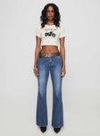 front view of model wearing Princess Polly Leslee Flare Jean Mid Wash Blue Mid Rise 