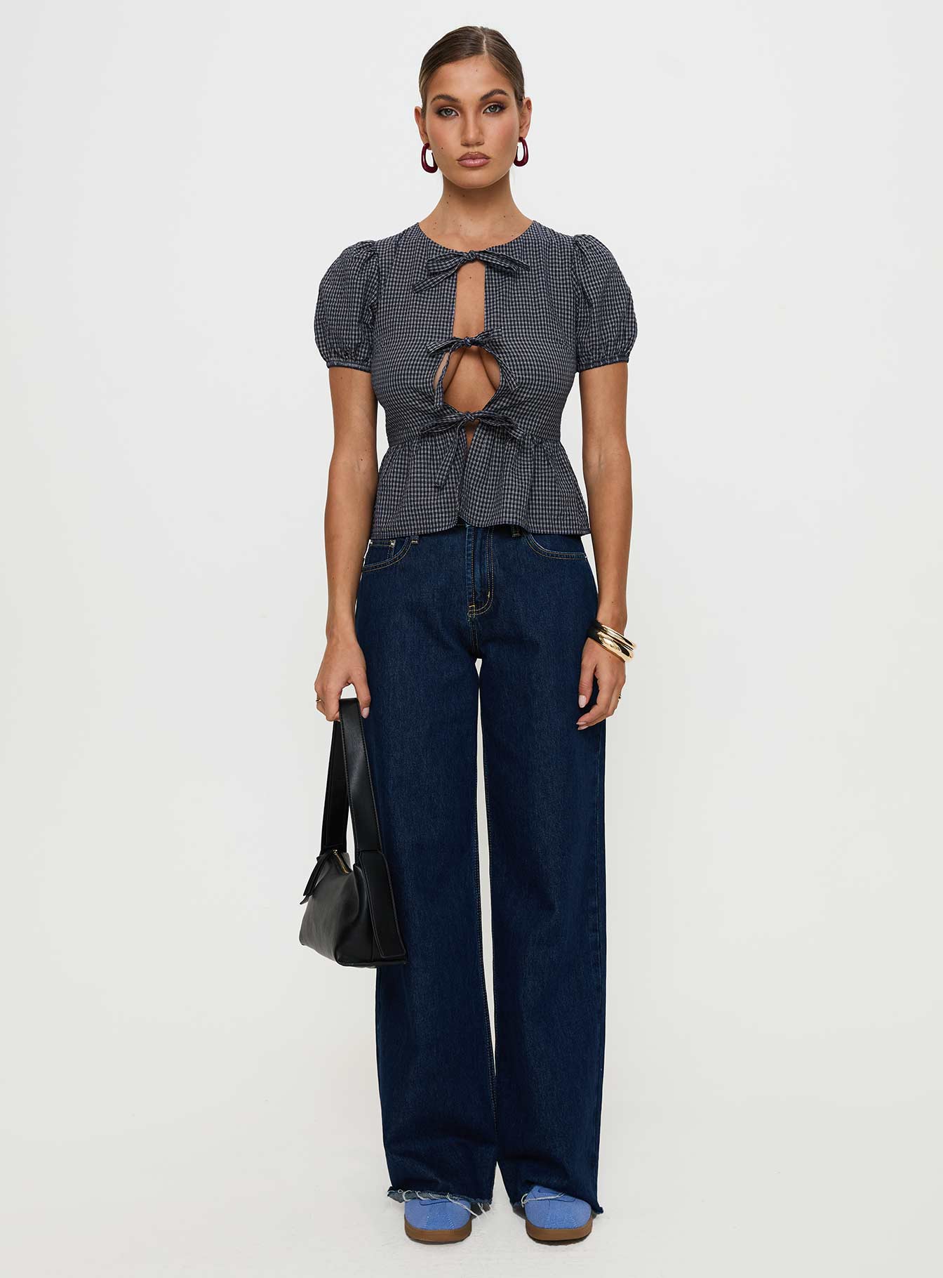 side view of model wearing Princess Polly Verah Tie Up Puff Sleeve Top Navy Check Short Sleeves Scoop Neck 