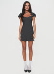 front view of model wearing Princess Polly Moretti Mini Dress Black Polka Dot Sweetheart Neckline 