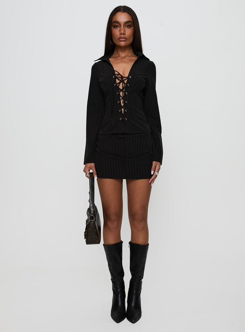 side view of model wearing Princess Polly Feminique Skort Black Stripe High Waisted Shorts 