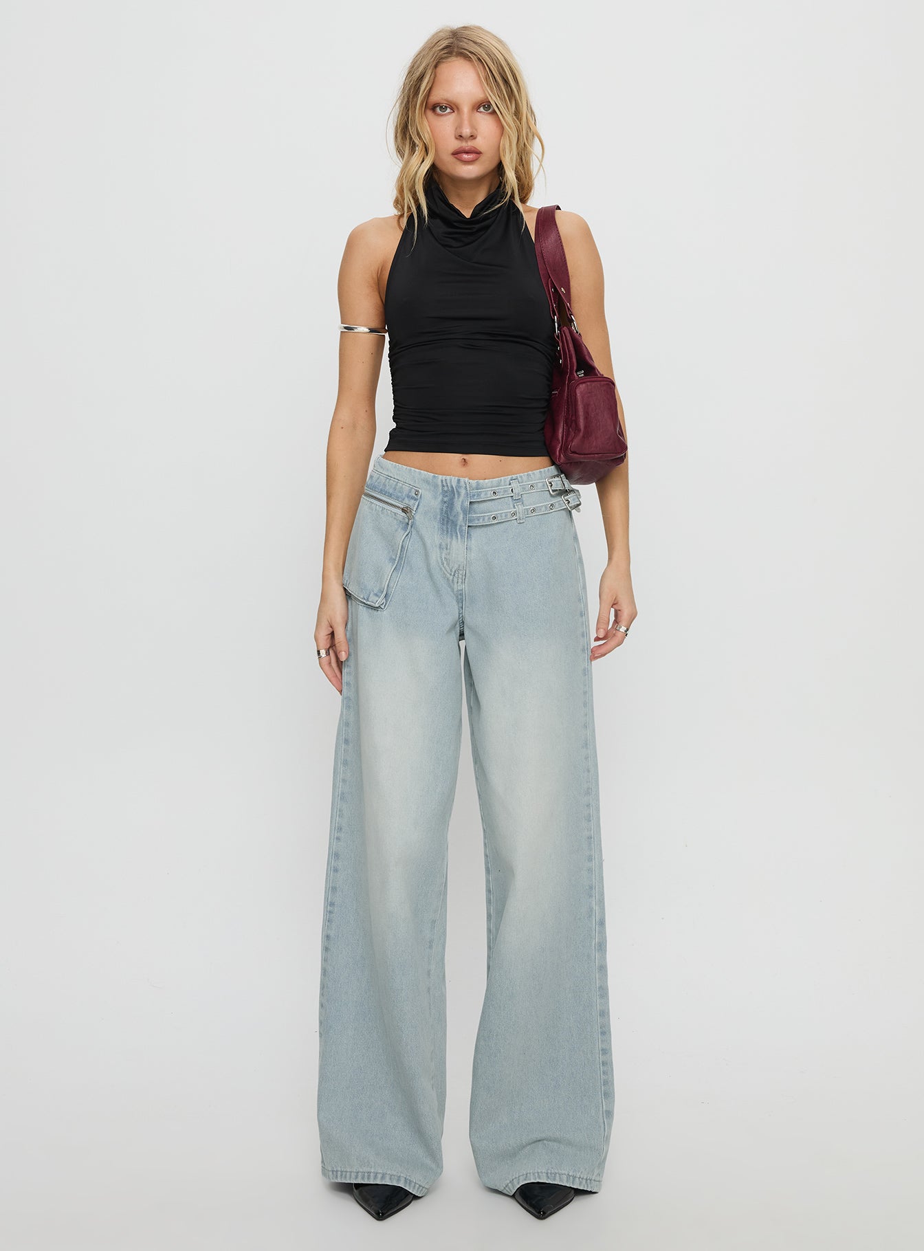 side view of model wearing Princess Polly Paltrow Mid Rise Wide Leg Cargo Jeans Faded Blue Wash Mid Rise Jeans 
