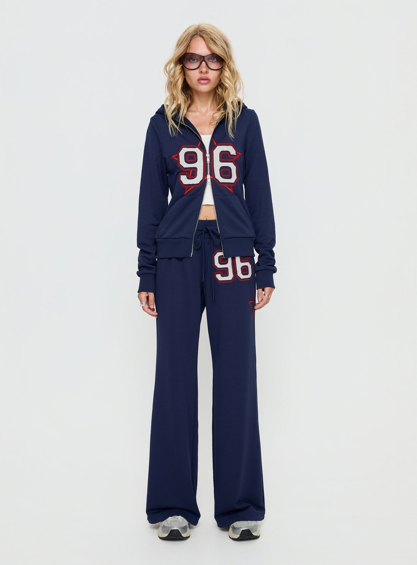 side view of model wearing Princess Polly Kari Distressed Patch Track Pant Navy Multi High Rise Pants 
