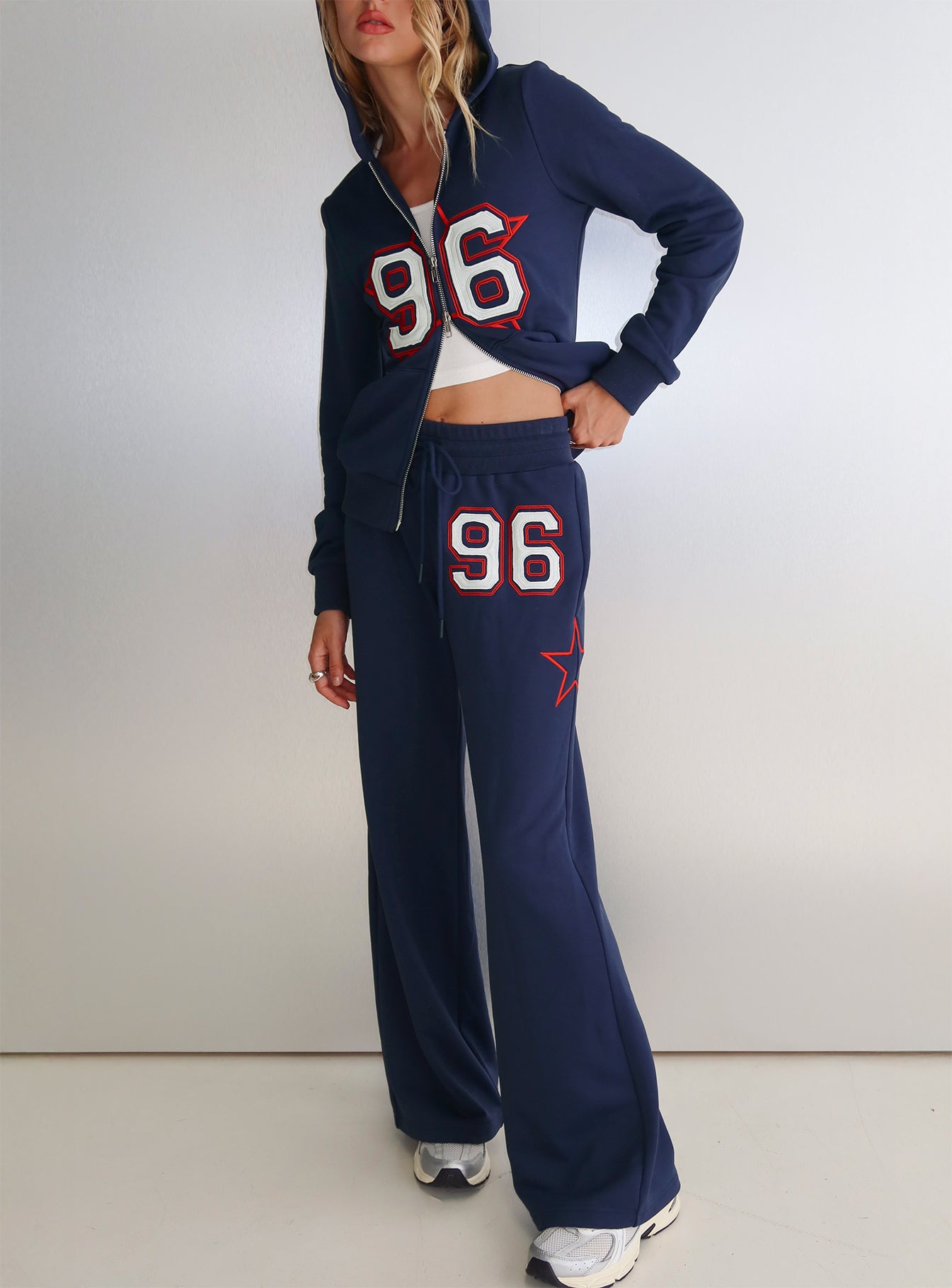 front view of model wearing Princess Polly Kari Distressed Patch Track Pant Navy Multi High Rise Pants 