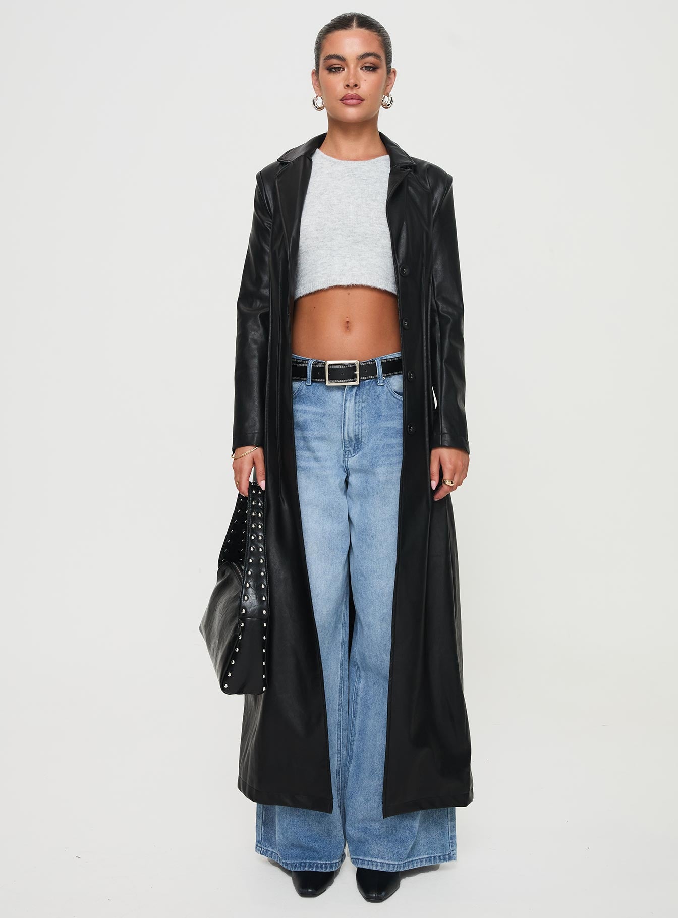 <ul> <li>Faux leather coat</li> <li>Lapel collar, button fastening down front, shoulder pads</li> </ul>