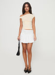   side view of model wearing Princess Polly Bubble Broderie Mini Skirt White Mini Skirts 