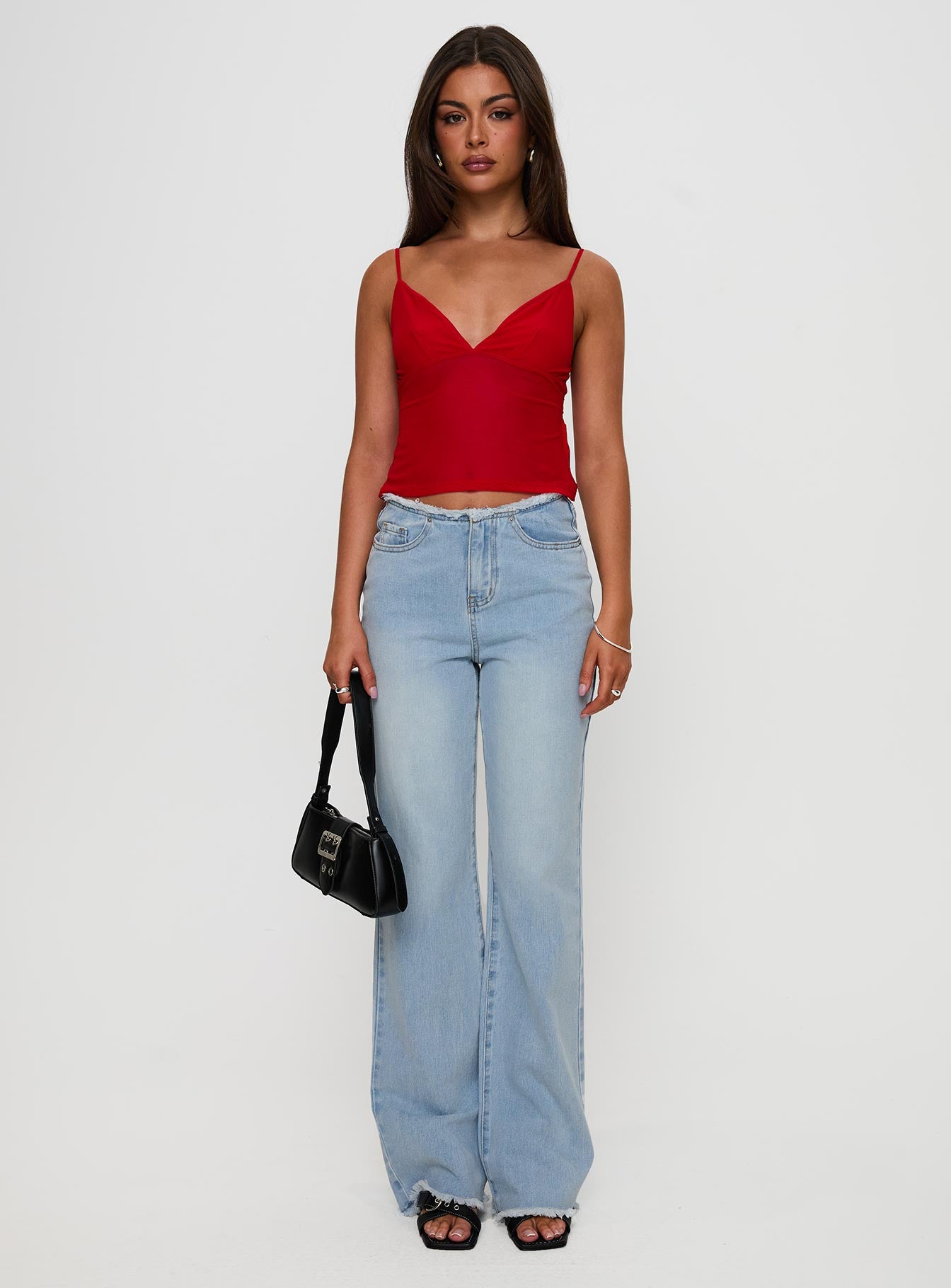 front view of model wearing Princess Polly Hawke Frayed Jeans Mid Blue High Waisted 