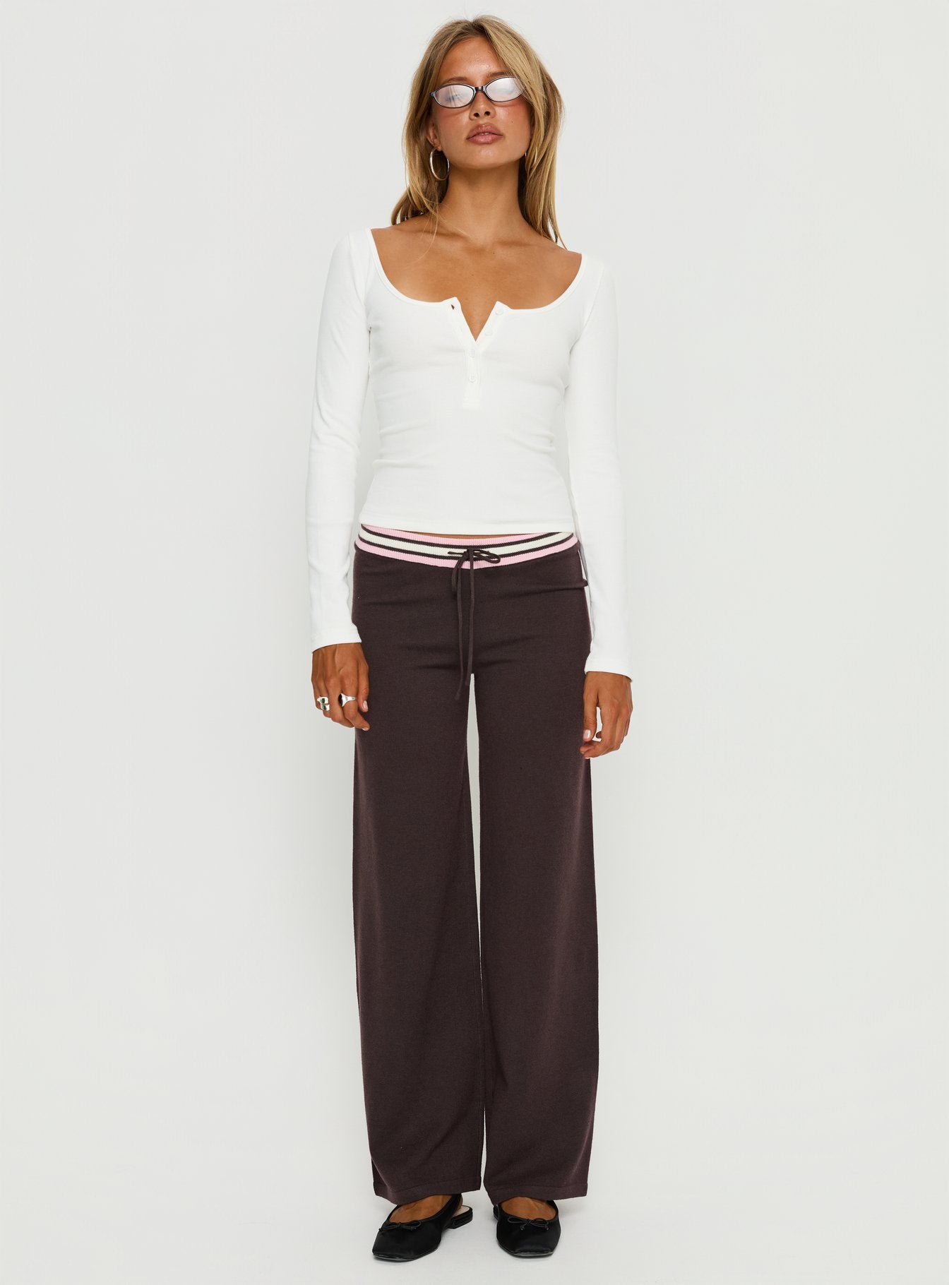 side view of model wearing Princess Polly Felisha Low Waist Knit Pants Brown Low Rise Pants 