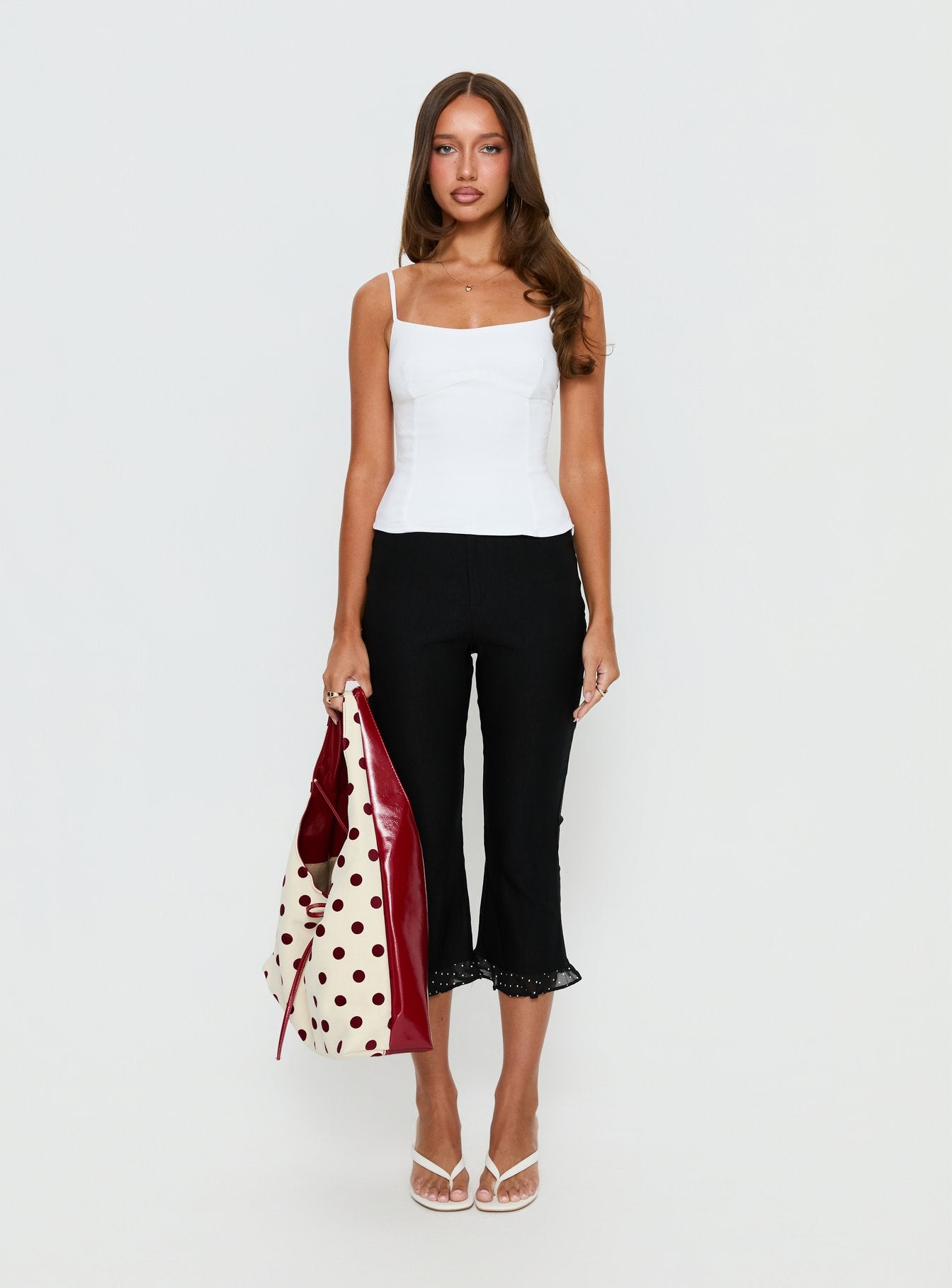 front view of model wearing Princess Polly Darsie Frill Capri Black Polka Dot High Rise Pants 