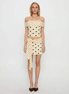   side view of model wearing Princess Polly Porzia Wrap Detail Mini Skirt Cream / Polka Dot Mini Skirts 