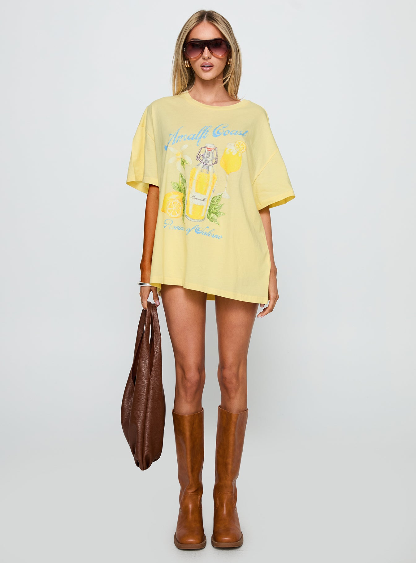 side view of model wearing Princess Polly Amalfi Coast Oversized Graphic Tee Pastel Yellow Half Sleeves Crew Neck 