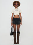 side view of model wearing Princess Polly Amethysta Denim Skort Black High Waisted Shorts 