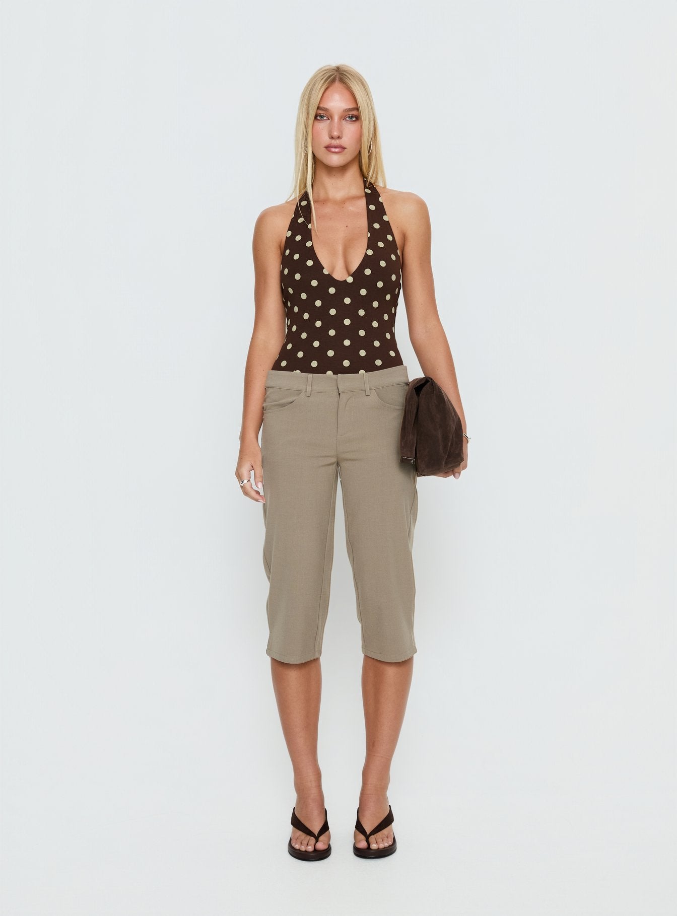 side view of model wearing Princess Polly Someone New Halter Bodysuit Chocolate Polka Sleeveless 