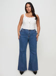 front view of model wearing Princess Polly Lucille High Rise Flare Leg Jeans Mid Wash Curve High Waisted 