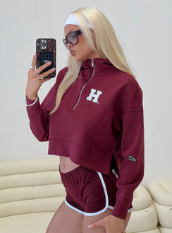 side view of model wearing Princess Polly Harvard Buttersport Half-zip Hoodie Crimson cropped 