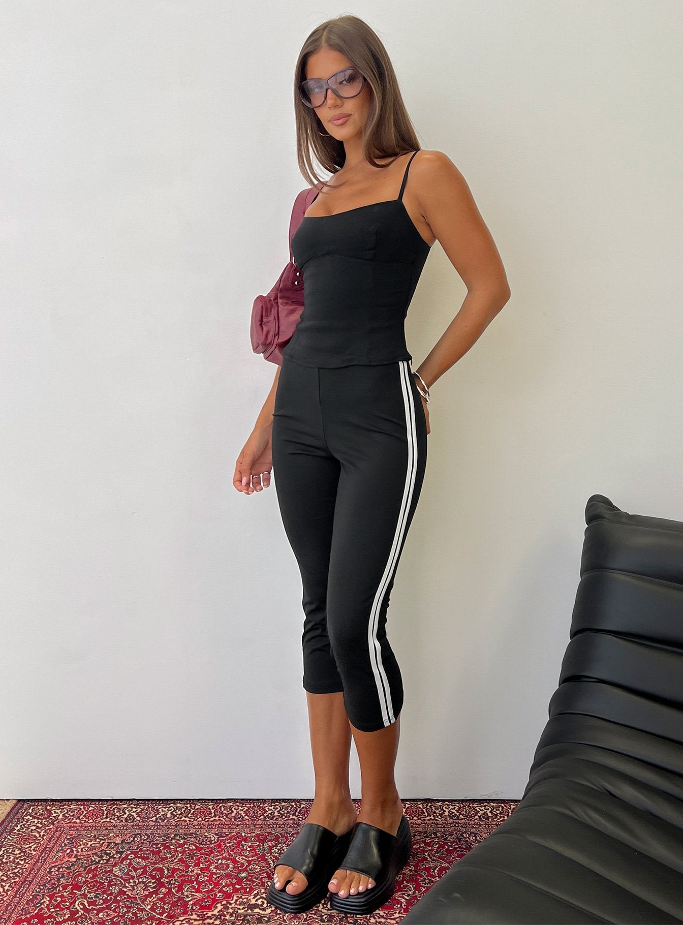 side view of model wearing Princess Polly Jobey Capri Pants Black High Rise Pants 