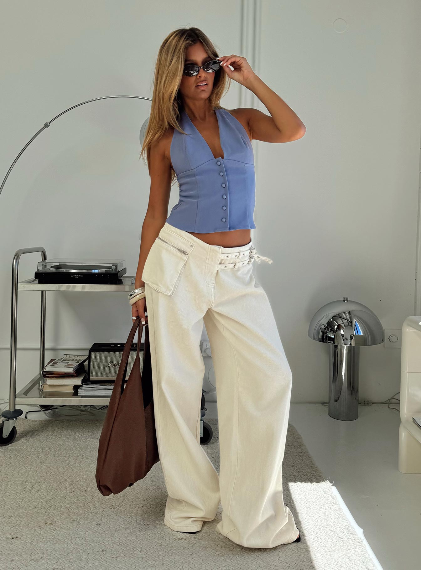 side view of model wearing Princess Polly Paltrow Mid Rise Wide Leg Cargo Jeans Cream Petite Low Rise Jeans 