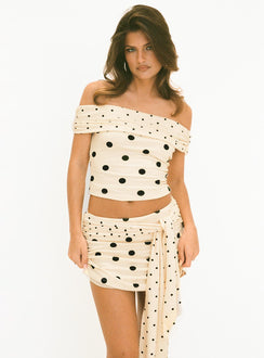   side view of model wearing Princess Polly Porzia Wrap Detail Mini Skirt Cream / Polka Dot Mini Skirts 