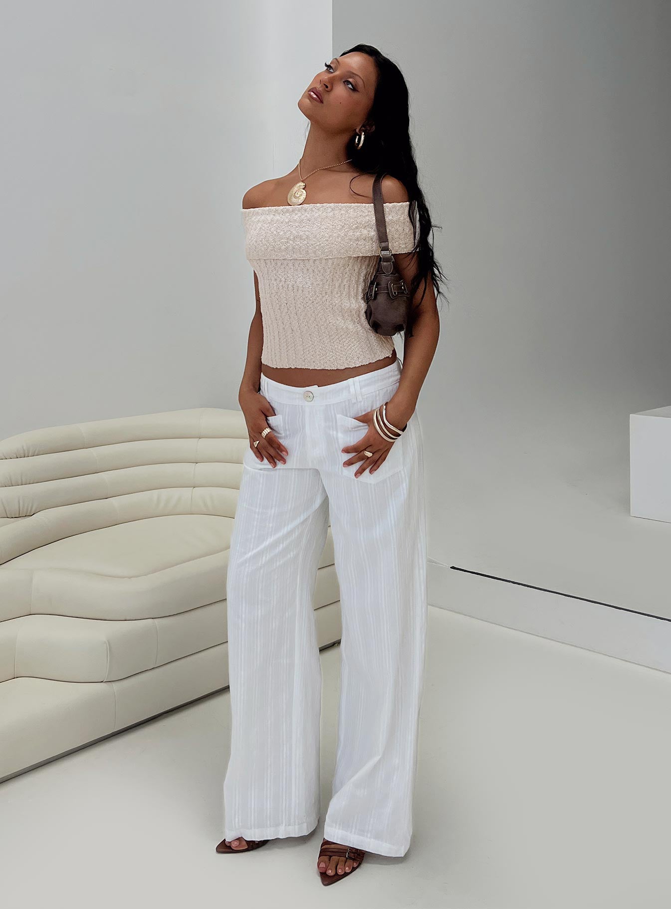 side view of model wearing Princess Polly Vendi Low Rise Pant White Low Rise Pants 