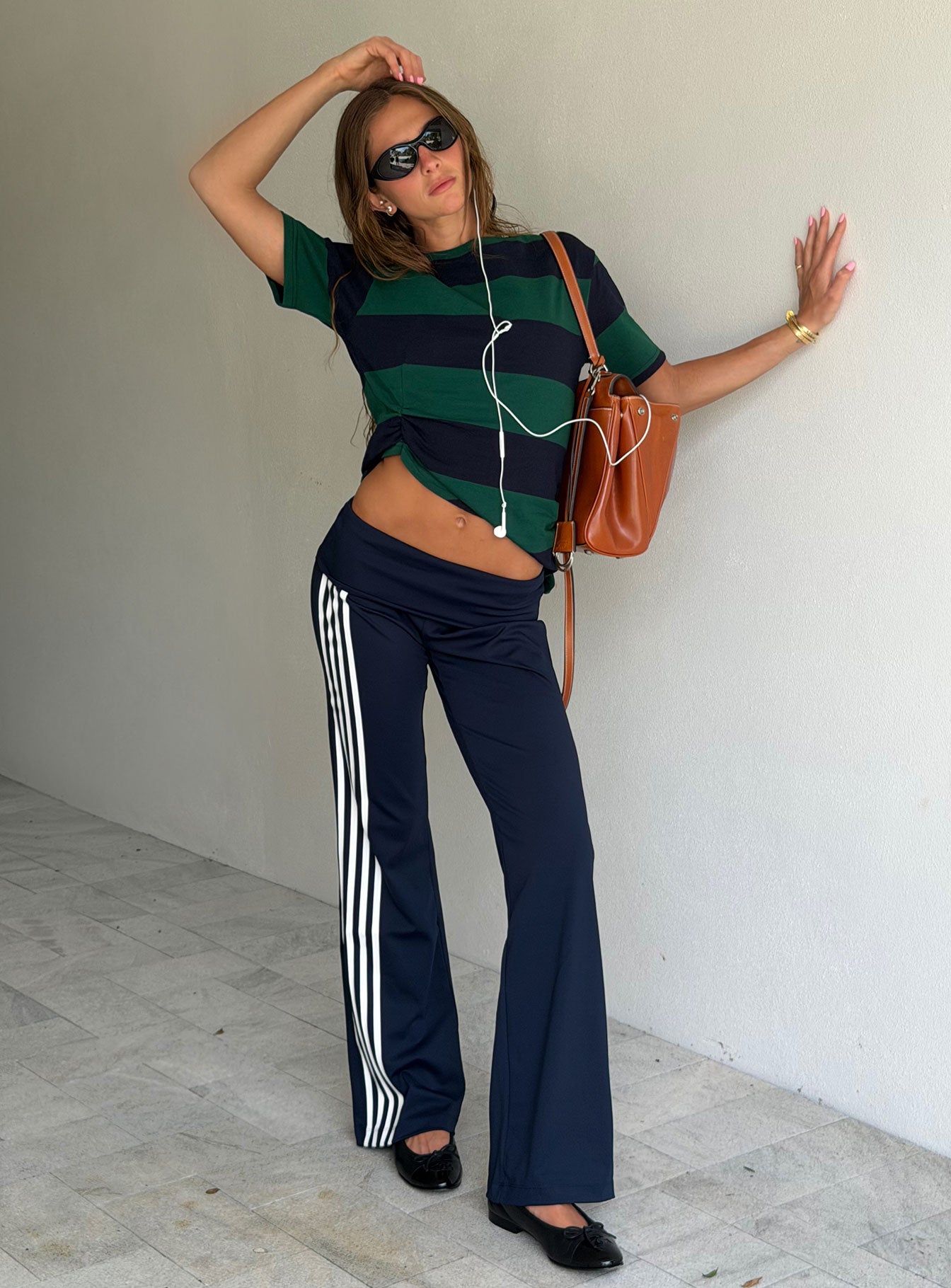 Showcasing the Layover Straight Leg Pants Navy Stripe in womens-regular-pants with mid-rise waist front view of model wearing Princess Polly