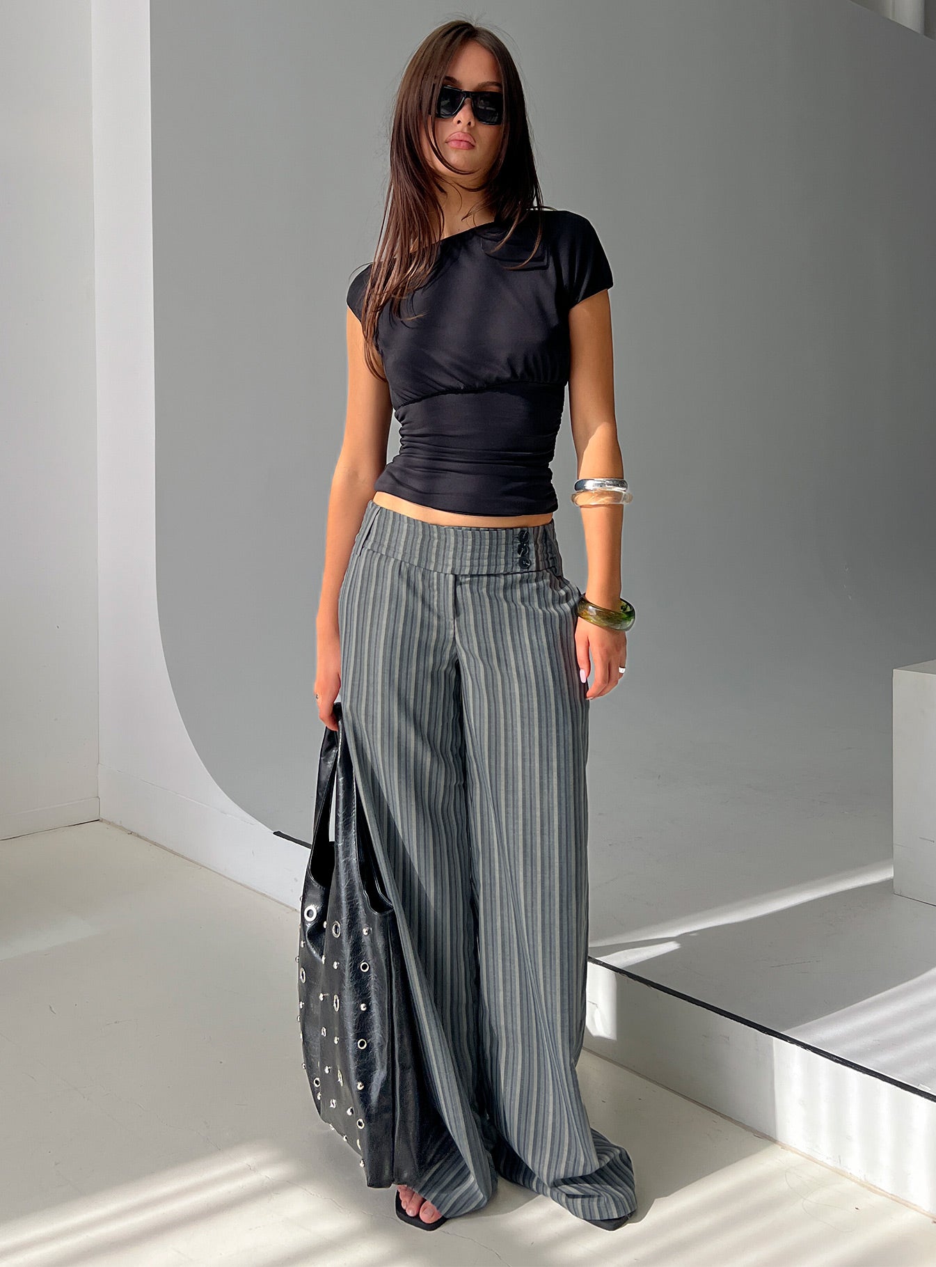 side view of model wearing Princess Polly Cedars Low Rise Pant Grey Stripe Low Rise Pants 