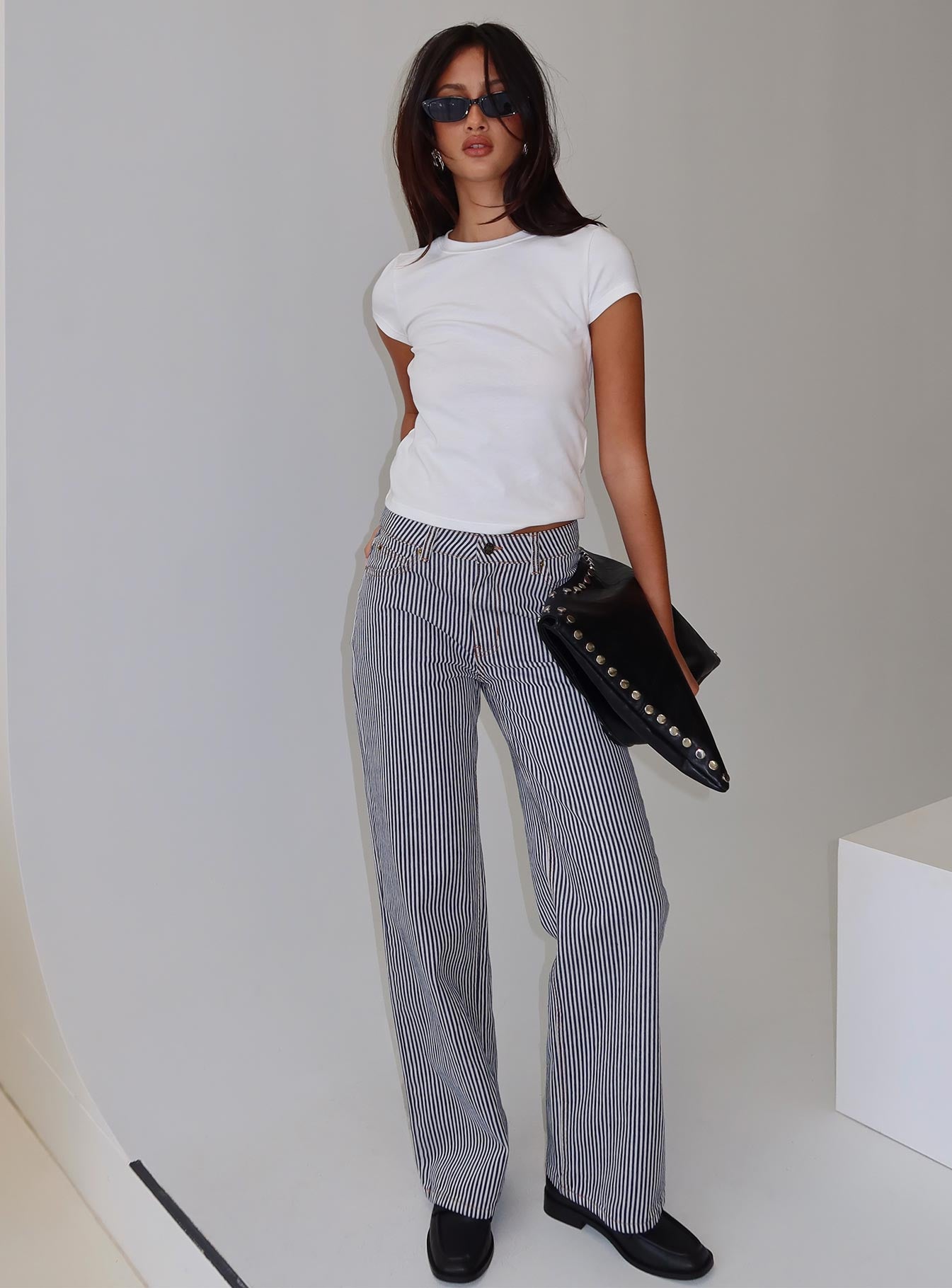 side view of model wearing Princess Polly Top Model Jean Navy Stripe Low Rise Pants 