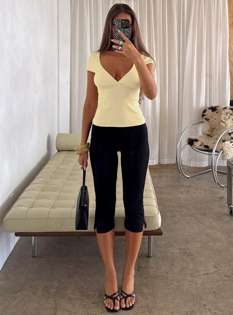 front view of model wearing Princess Polly Baseline Rib Capri Pants Black Petite Mid Rise Pants 