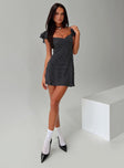 side view of model wearing Princess Polly Moretti Mini Dress Black Polka Dot Sweetheart Neckline 