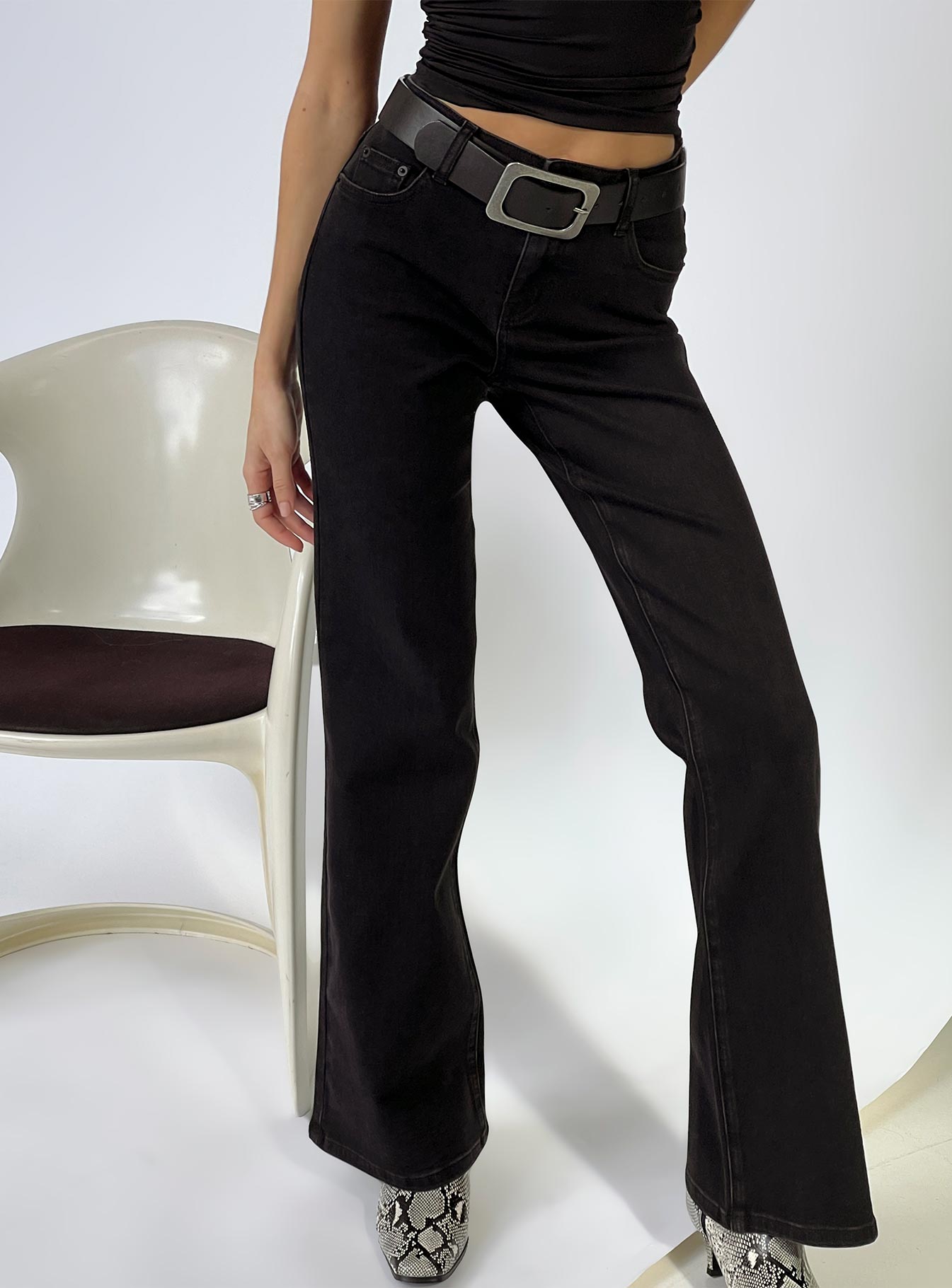 back view of model wearing Princess Polly Magic Mirror Mid Rise Bootleg Jeans Washed Black Mid Rise Jeans 