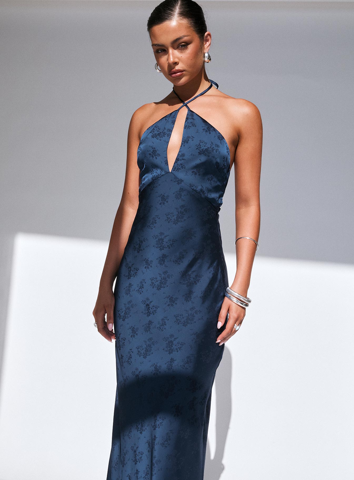 side view of model wearing Princess Polly Limosina Halter Maxi Dress Navy Plunger 