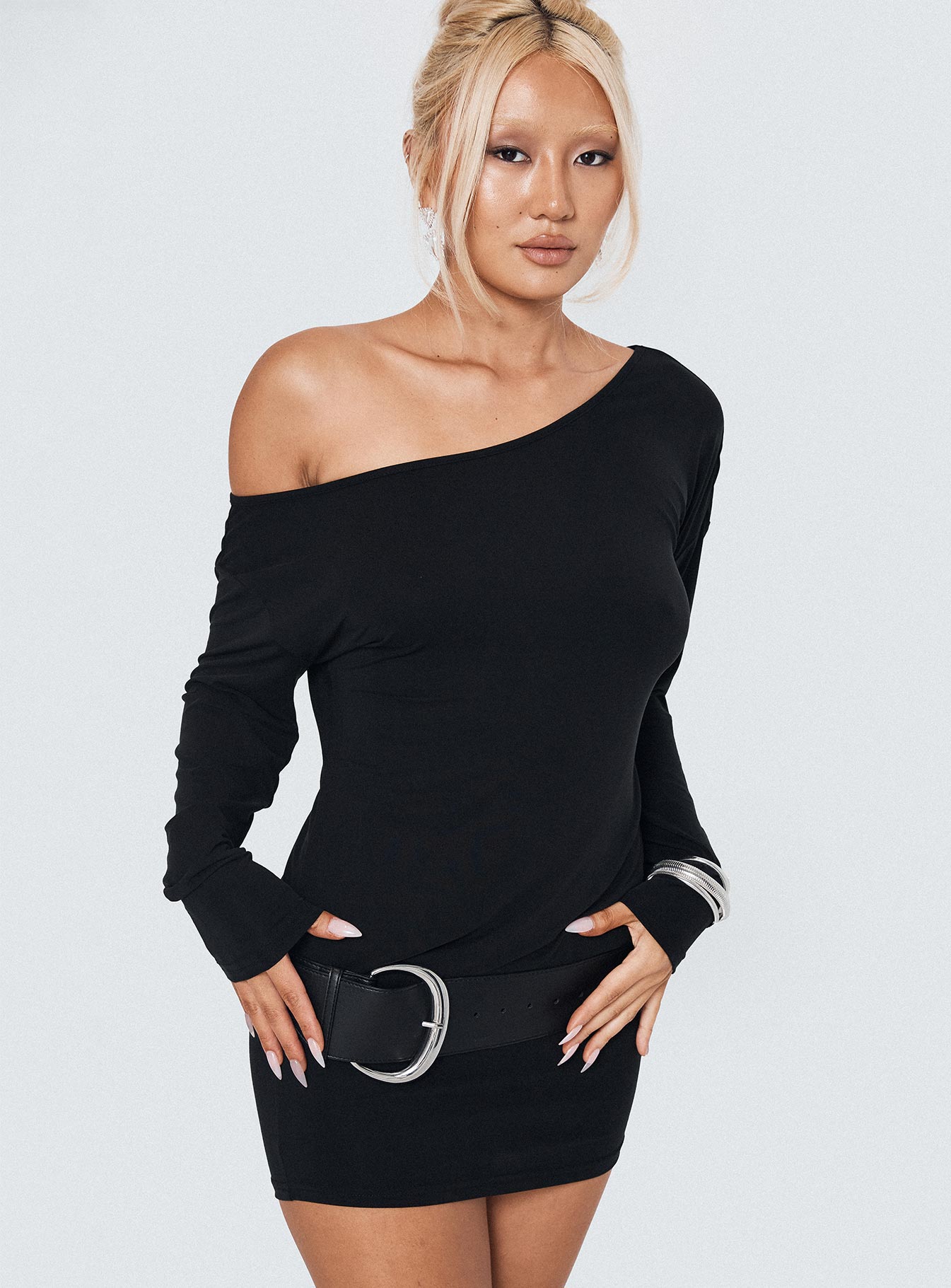 front view of model wearing Princess Polly Shelisa Mini Dress Black Asymmetric Neckline 