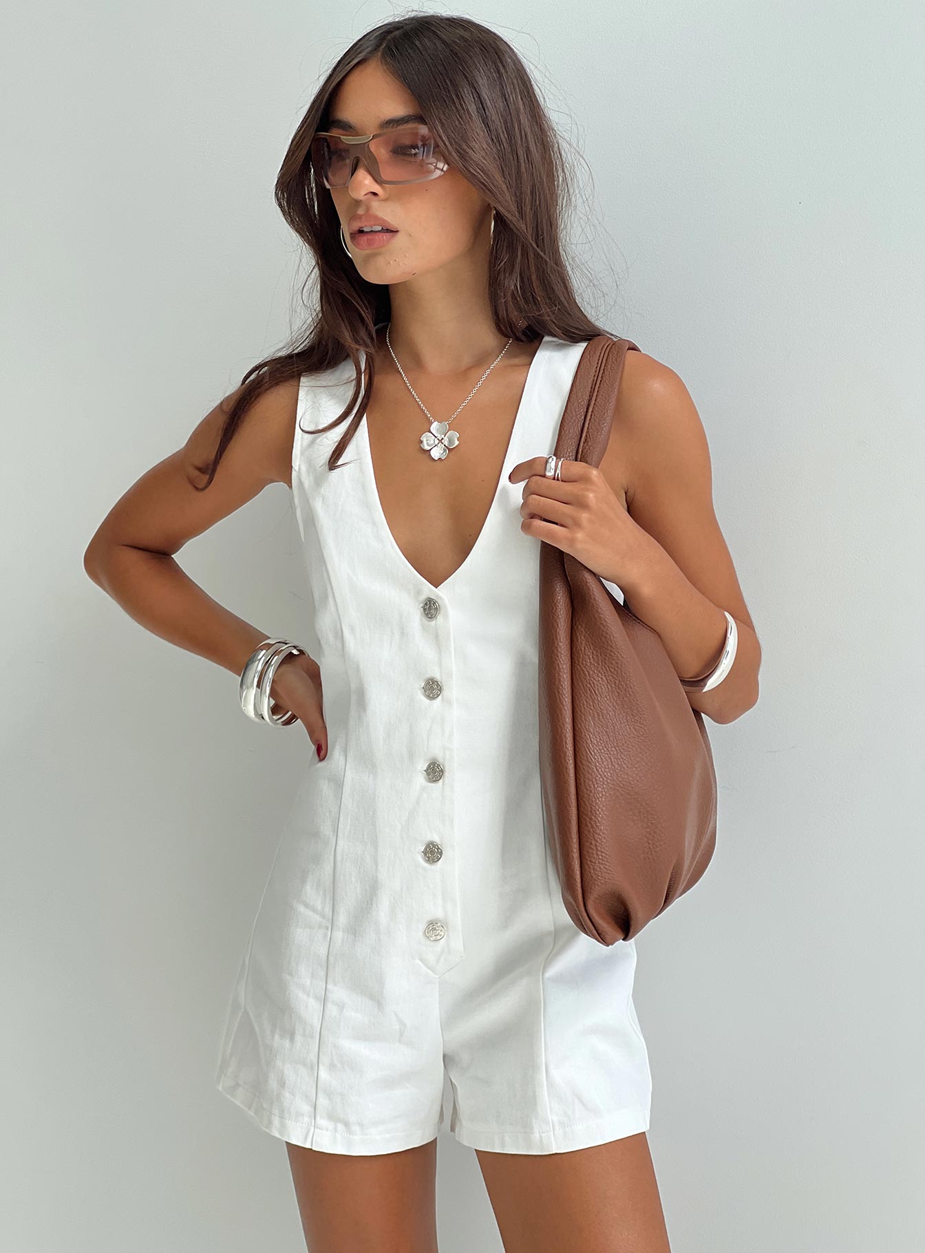 Romper Fixed shoulder straps, scooped neckline, button fastening down front Non-stretch material, unlined 