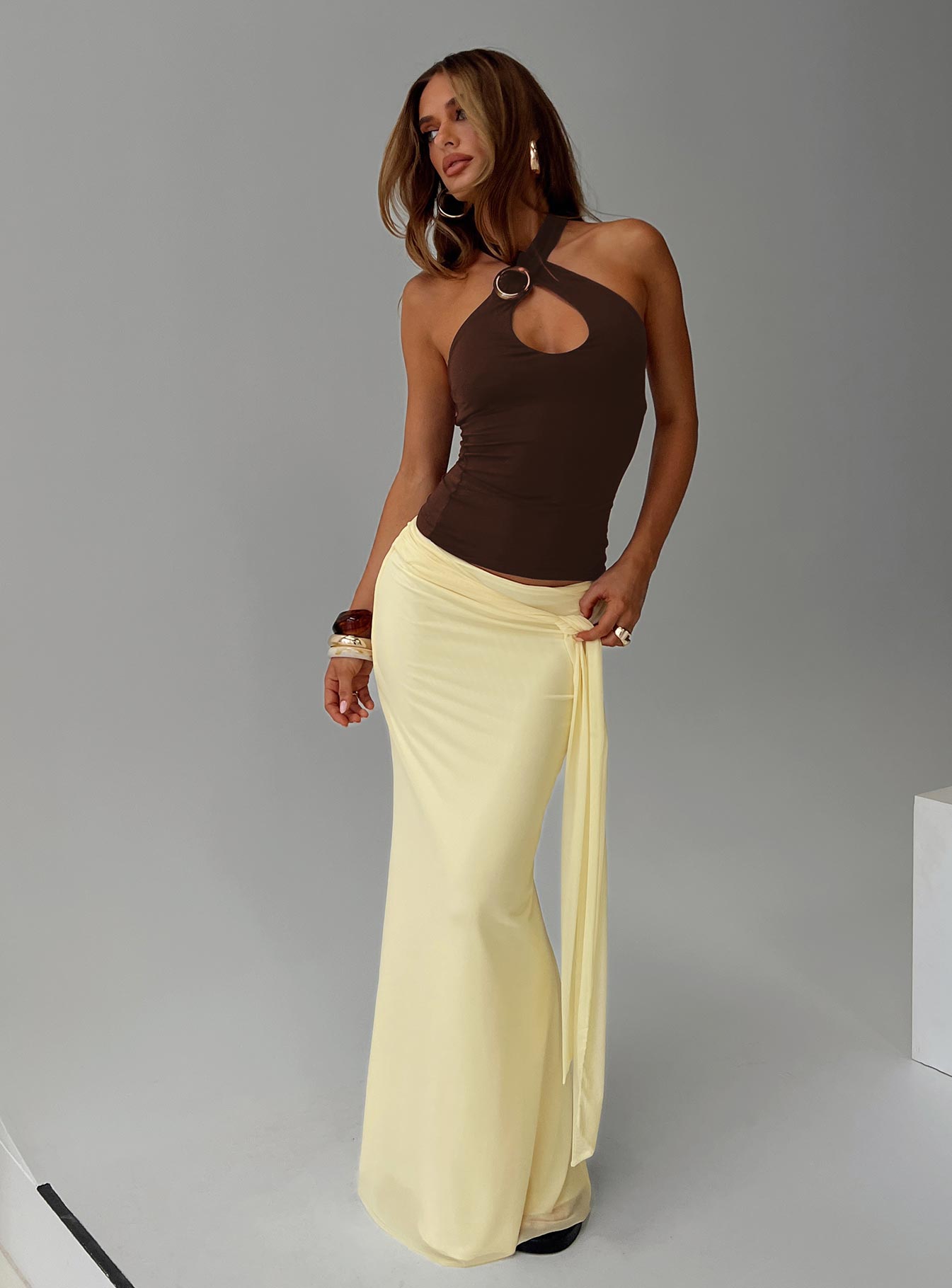   side view of model wearing Princess Polly Caviar Tie Maxi Skirt Lemon 