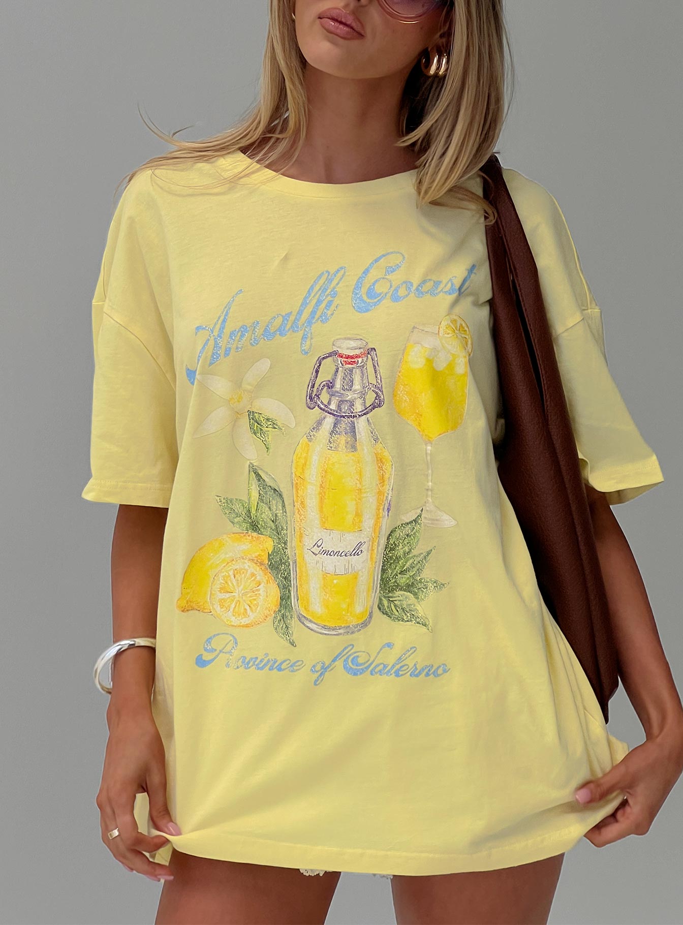 front view of model wearing Princess Polly Amalfi Coast Oversized Graphic Tee Pastel Yellow Half Sleeves Crew Neck 