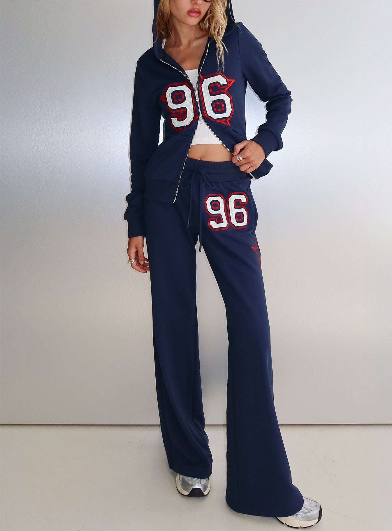 front view of model wearing Princess Polly Kari Distressed Patch Track Pant Navy Multi High Rise Pants 