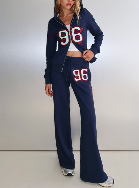 front view of model wearing Princess Polly Kari Distressed Patch Track Pant Navy Multi High Rise Pants 