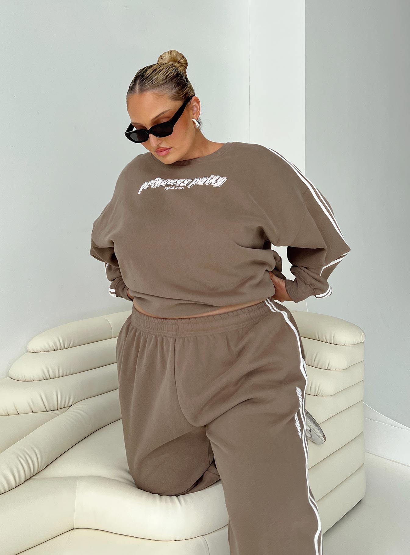 side view of model wearing Princess Polly Princess Polly Crew Neck Sweatshirt Stripe Taupe / White Curve 