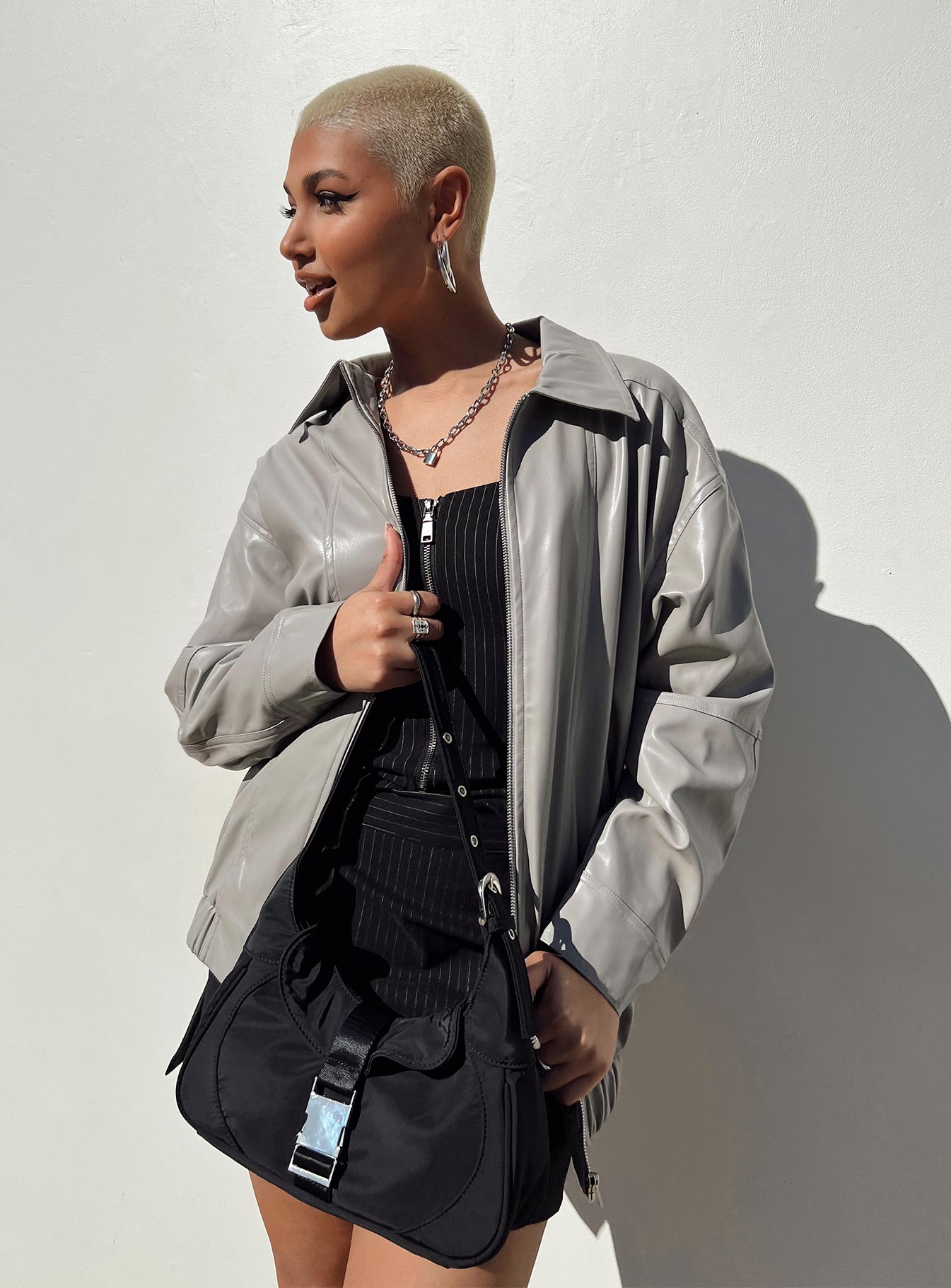 Grey bomber jacket Faux leather material Pointed collar Zip front fastening Twin hip pockets Elasticated waistband