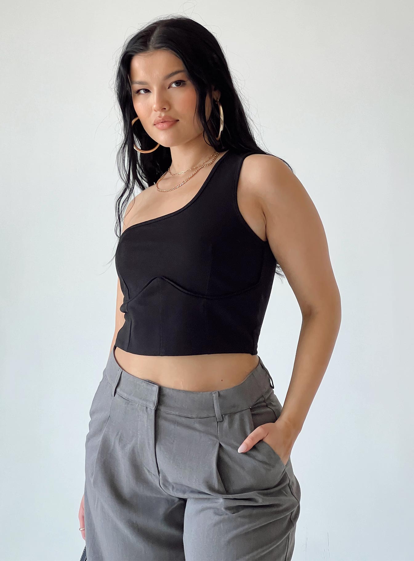 back view of model wearing Princess Polly Meranti Top Black Sleeveless Asymmetric Neckline 