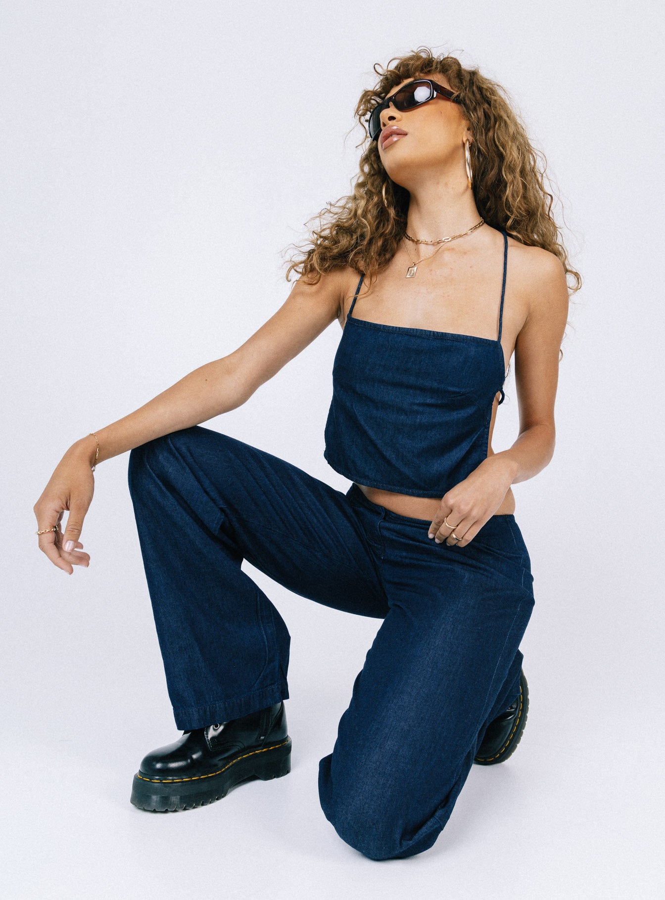Front view of model wearing  front Princess Polly Sleeveless High Neck  Motel Rosta Top Denim Blue