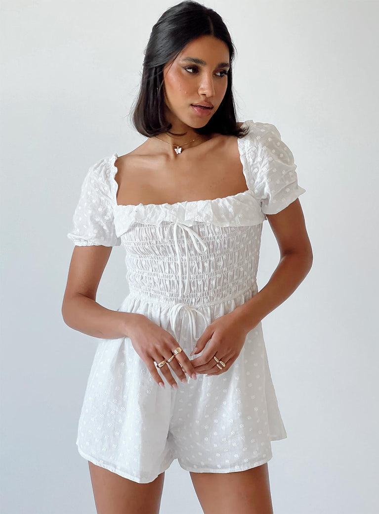 White romper Sheer design  Floral stitched material  Elasticated shoulders Puff sleeves Frill neckline  Shirred bust Fixed tie at waist 