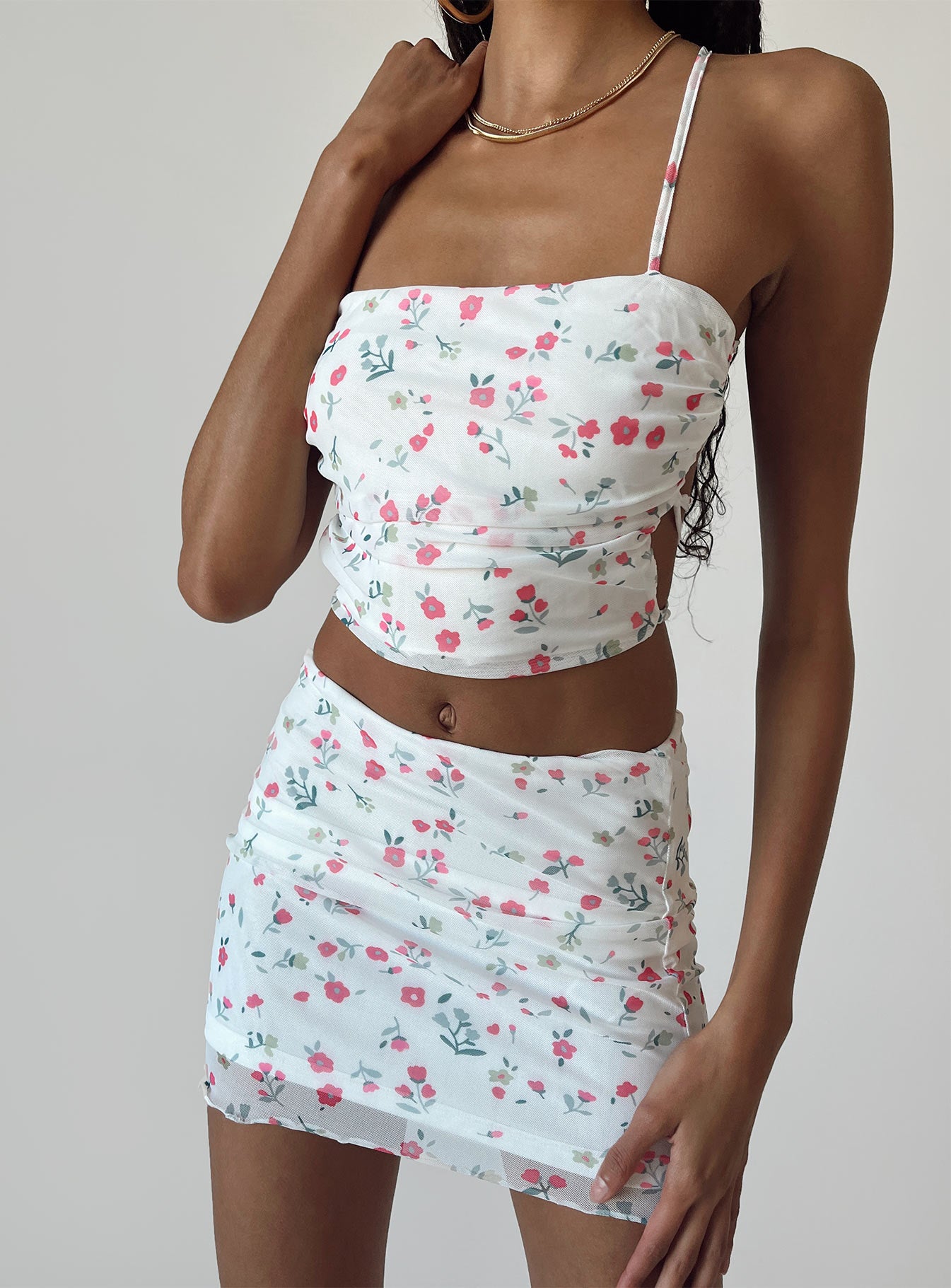 Matching set Mesh material  Floral print  Cowl neckline  Lace-up back tie fastening  High waisted mini skirt  Elasticated waist  Lettuce edge hem 