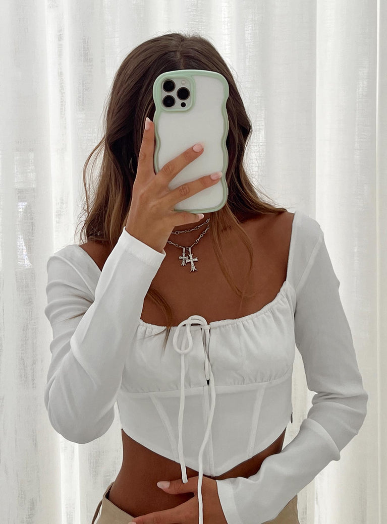 White long sleeve top Square neckline Inner silicone strip at shoulders Tie fastening at front Boning through front Pointed hem