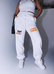 front view of model wearing Princess Polly Jasmine Graphic Track Pants White 