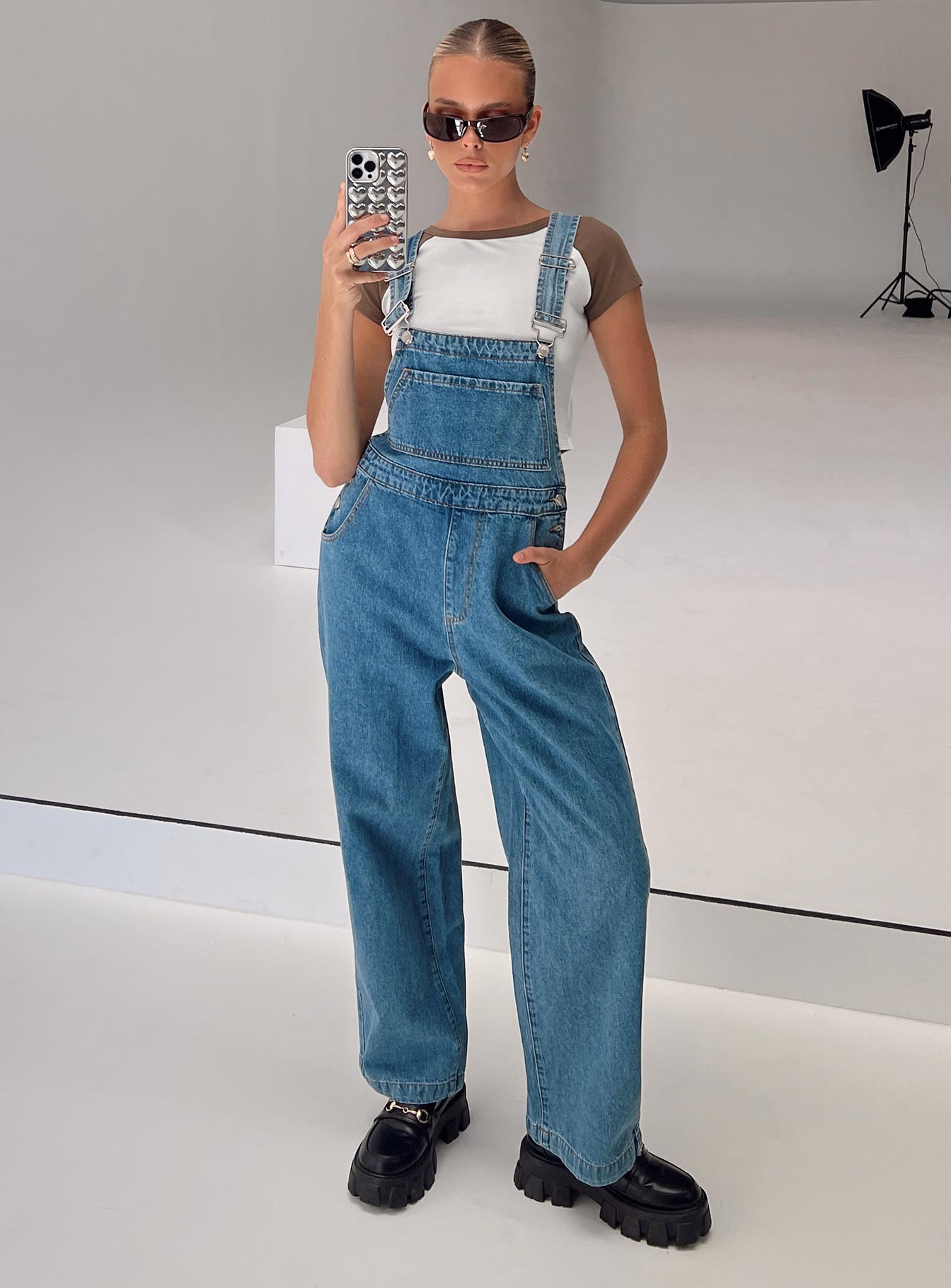 Overalls Mid wash denim Adjustable shoulder strap  Large chest pocket  Four classic pockets  Button fastening at hips  Wide leg