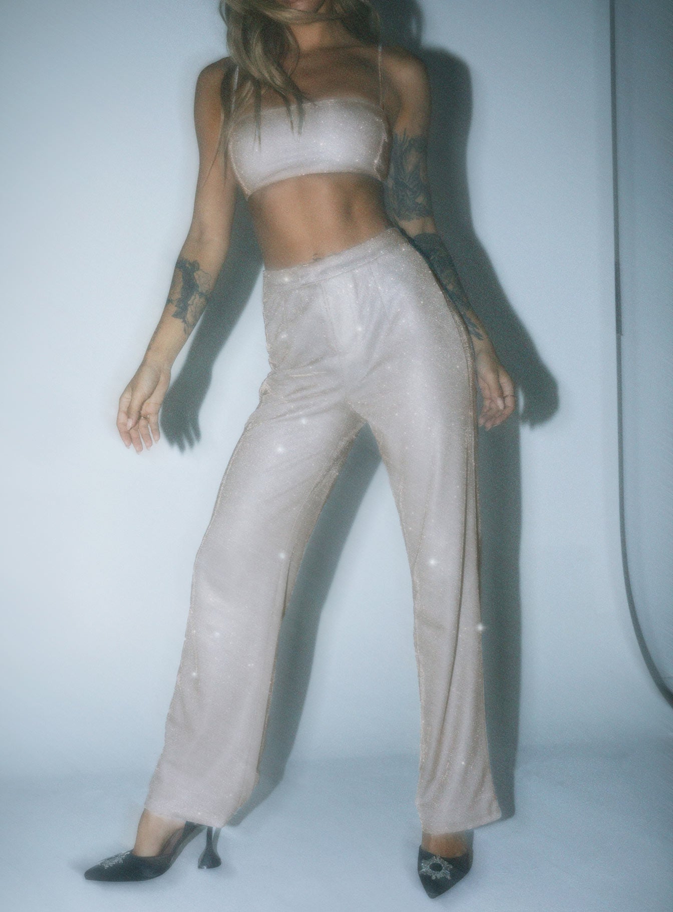 Matching set Sparkly material Crop top Adjustable shoulder straps Zip fastening at back Pants High rise Zip & clasp fastening  Subtle pleats at waist Straight leg